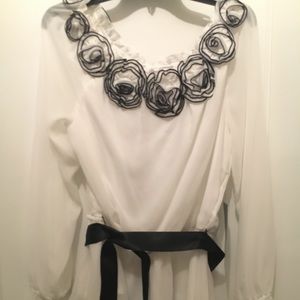 Blouse with floral accents at neckline